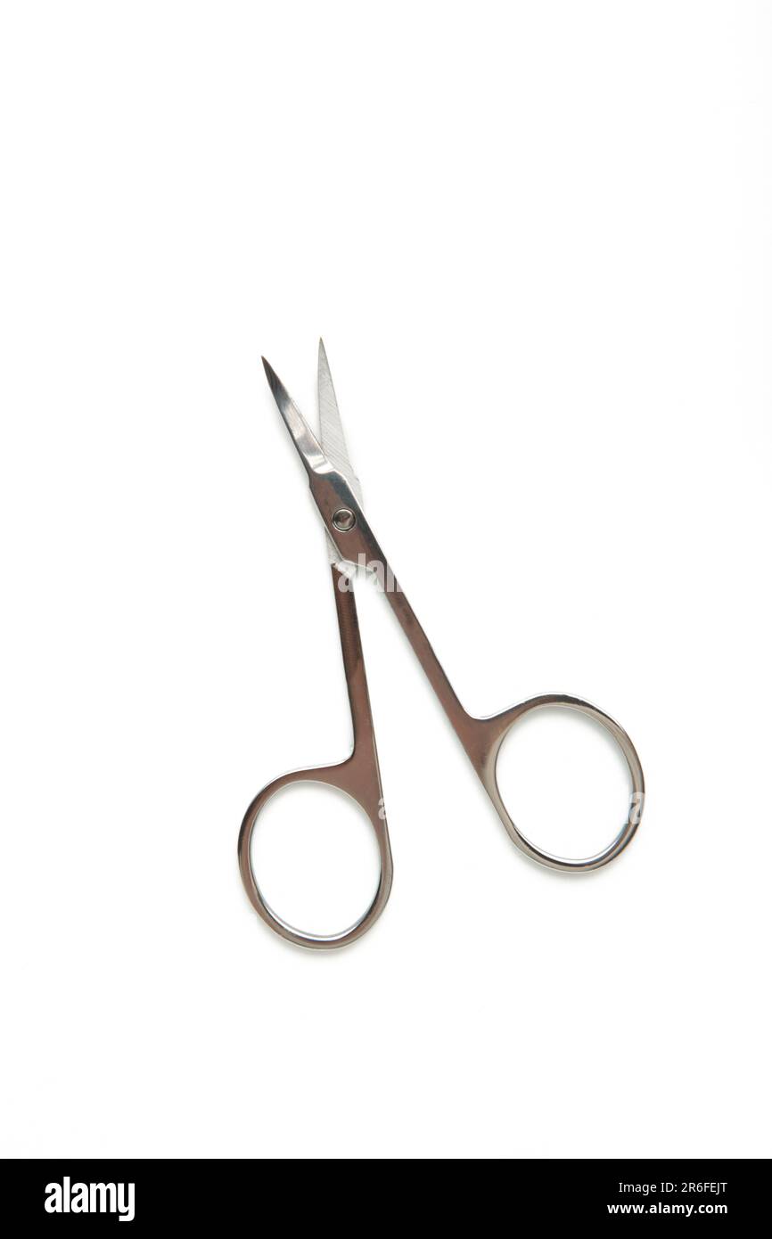 Small metal manicure scissors isolated on white background. Top view Stock Photo