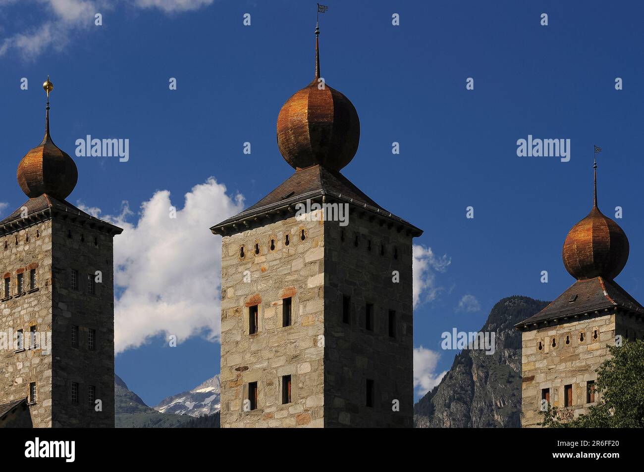 Three square towers, each topped by a gilded onion dome, of the