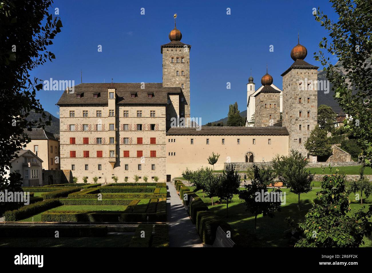 The Baroque Stockalper Palace or Stockalperpalast, its three square towers each topped by a gilded onion dome, at Brig in Valais Canton, Switzerland.  Built in the 1600s by fabulously wealthy entrepreneur, Kaspar Stockalper, the palace was the largest secular building in Switzerland at the time of its construction. Stock Photo