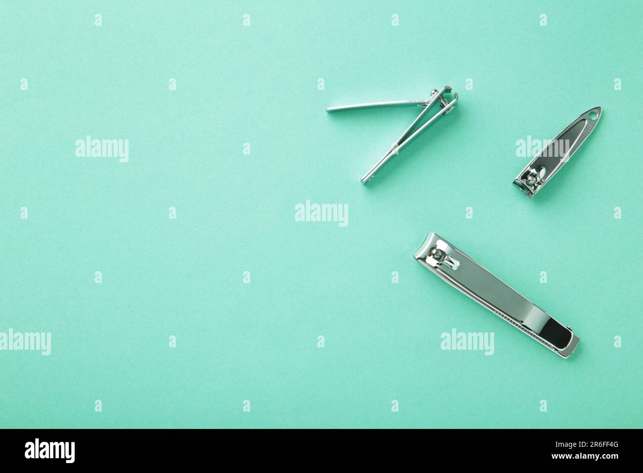 Nail clippers on mint background. Top view Stock Photo