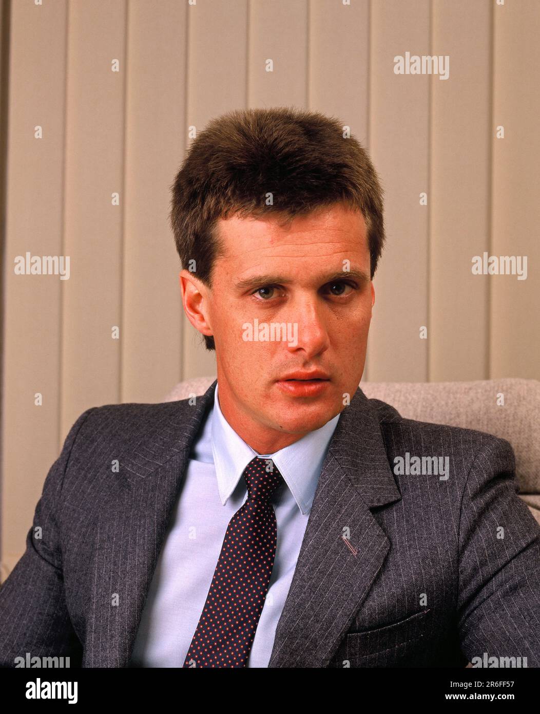 Business. Portrait of young executive man sitting in office. Stock Photo