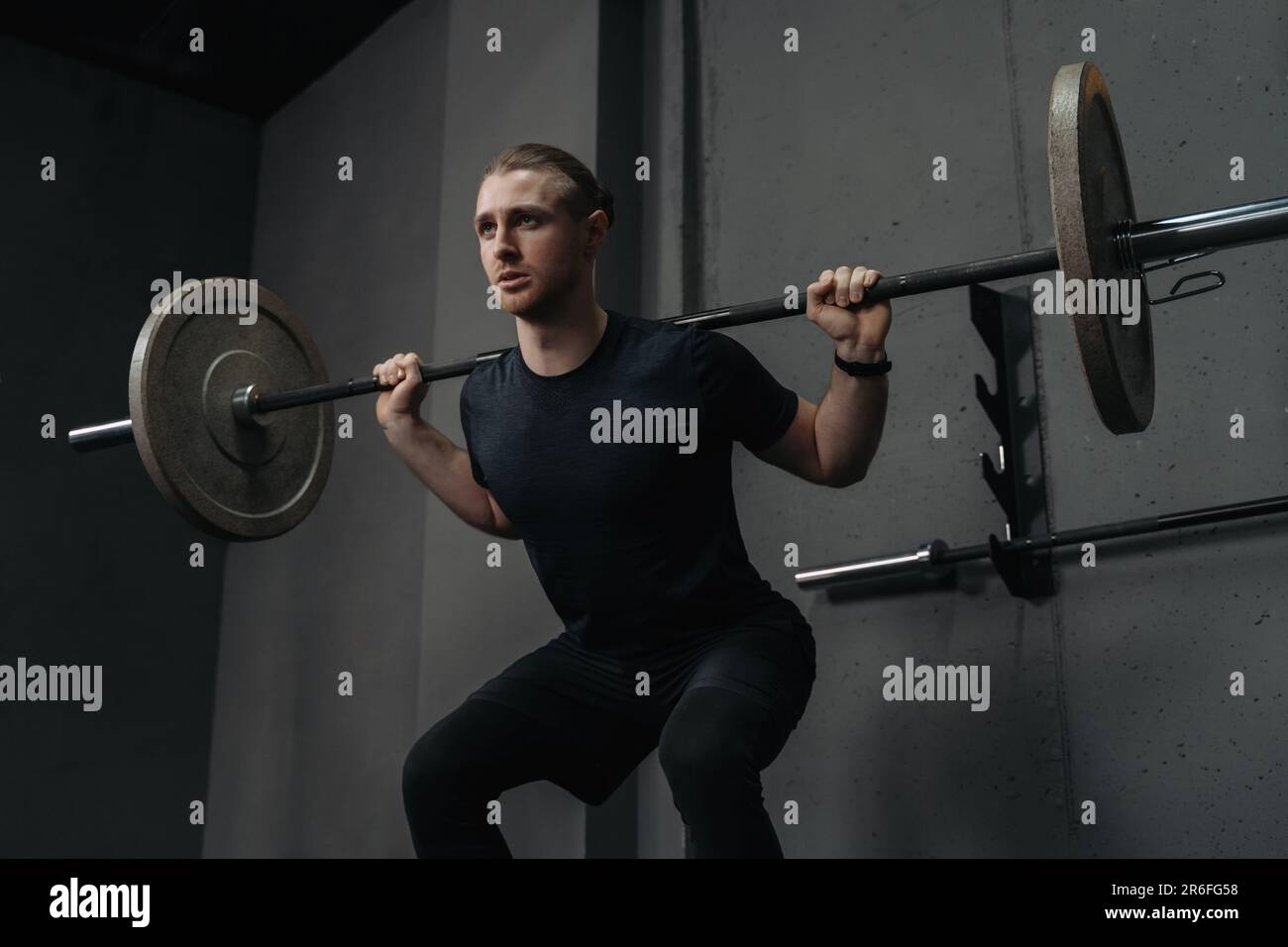 Strong crossfit athlete having workout and bodybuilding with barbells