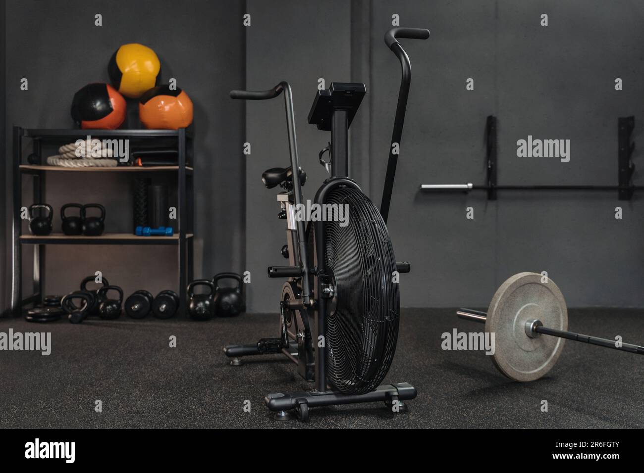 Empty crossfit gym with sports equipment air bike barbell kettlebells dumbbells weighted balls battle ropes. Copy space. Workout bodybuilding and fitness content Stock Photo Alamy