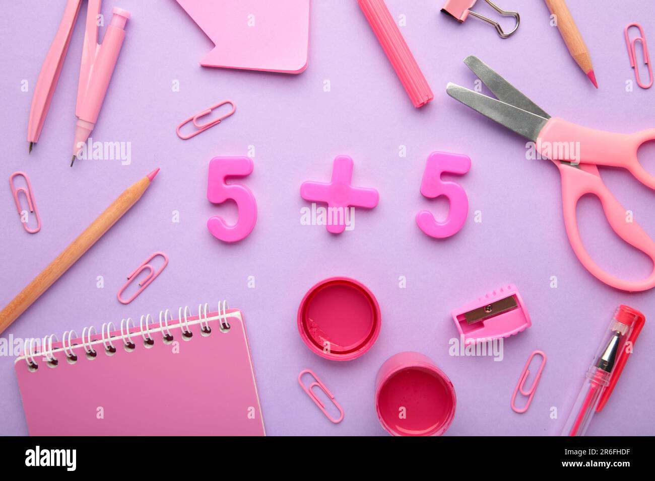 Purple school supplies on purple background. Back to school concept