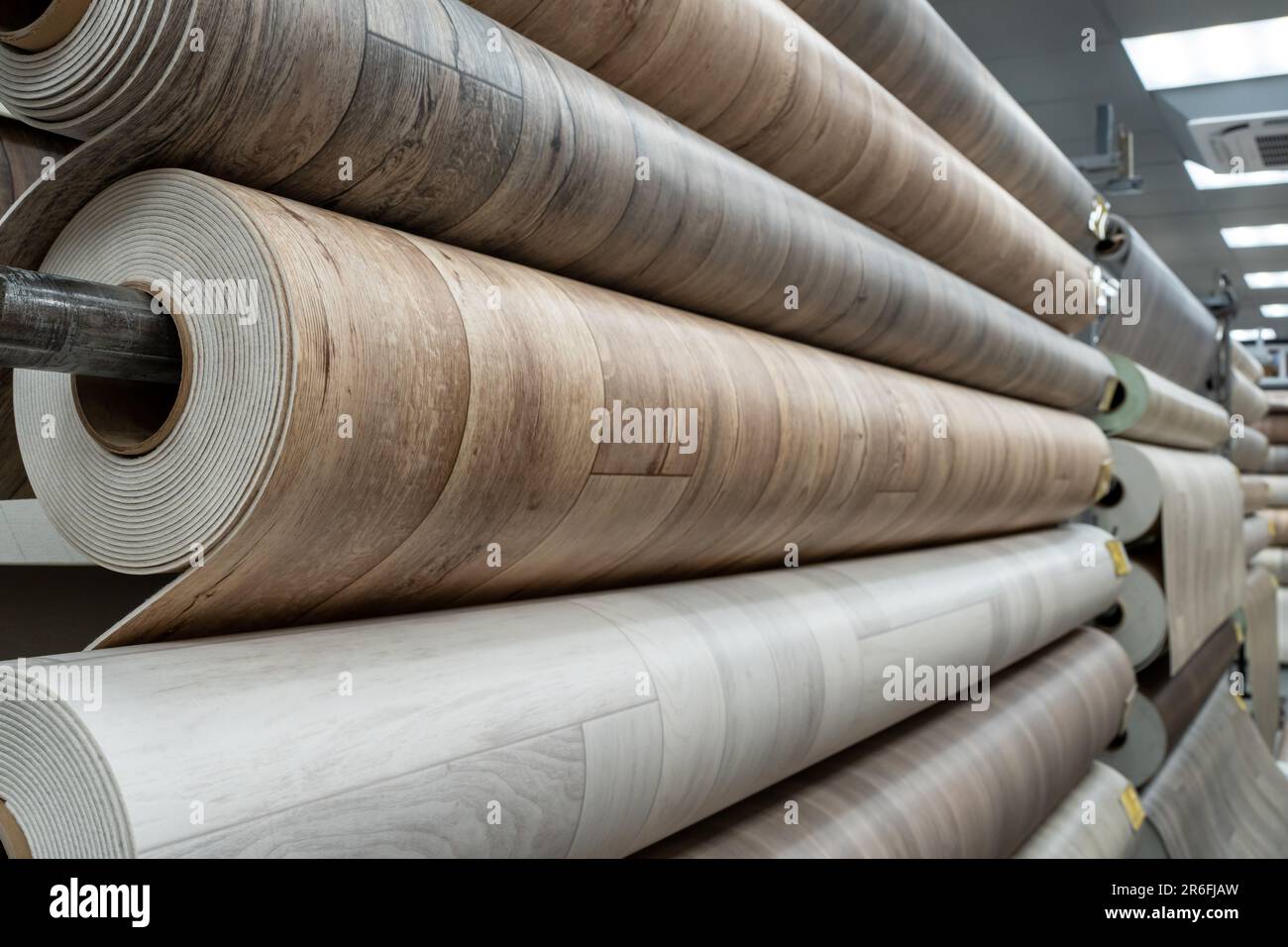 Rolls of new linoleum on the window of a hardware store. A large selection of linoleum Stock Photo