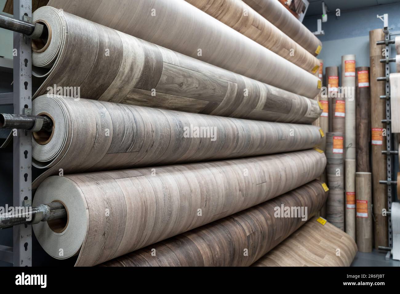Rolls of new linoleum on the window of a hardware store. A large selection of linoleum Stock Photo