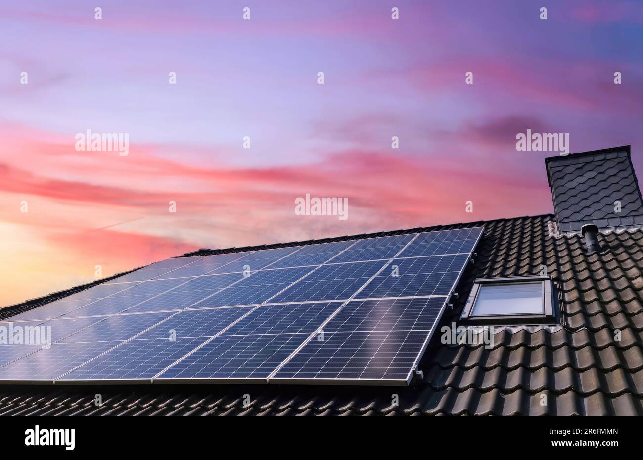 Solar panels producing clean energy on a roof of a residential house ...