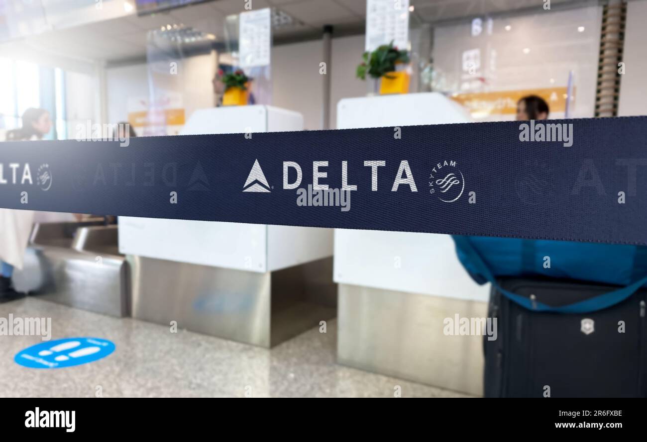 New York, US May 2023: Blue retractable belt barrier with white Delta Airlines and SkyTeam logos. Major American airline. Travel and airport security. Stock Photo