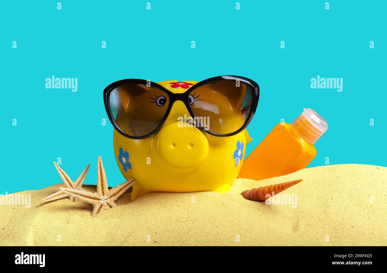 Summer piggy bank with sunglasses on the beach Stock Photo - Alamy