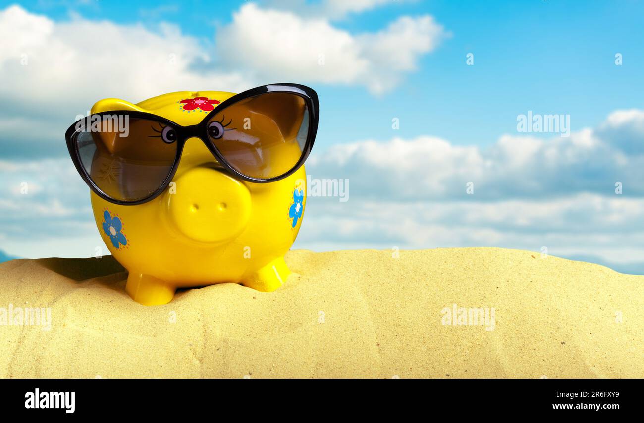 Summer piggy bank with sunglasses on the beach Stock Photo - Alamy