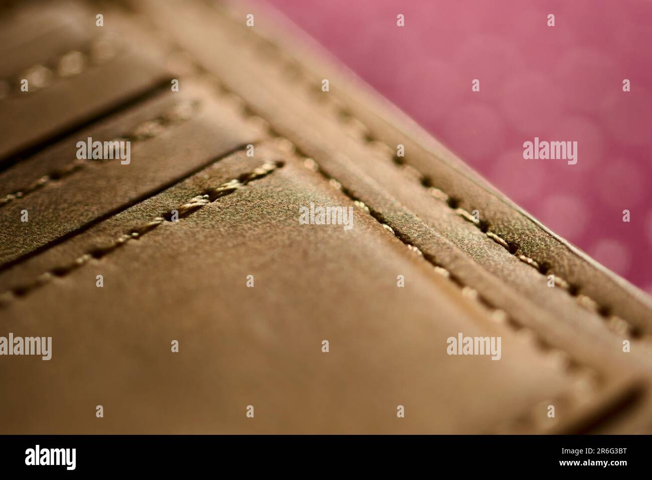 Handmade tan leather wallet, detail of the stitching. Close up, macro shot. Stock Photo