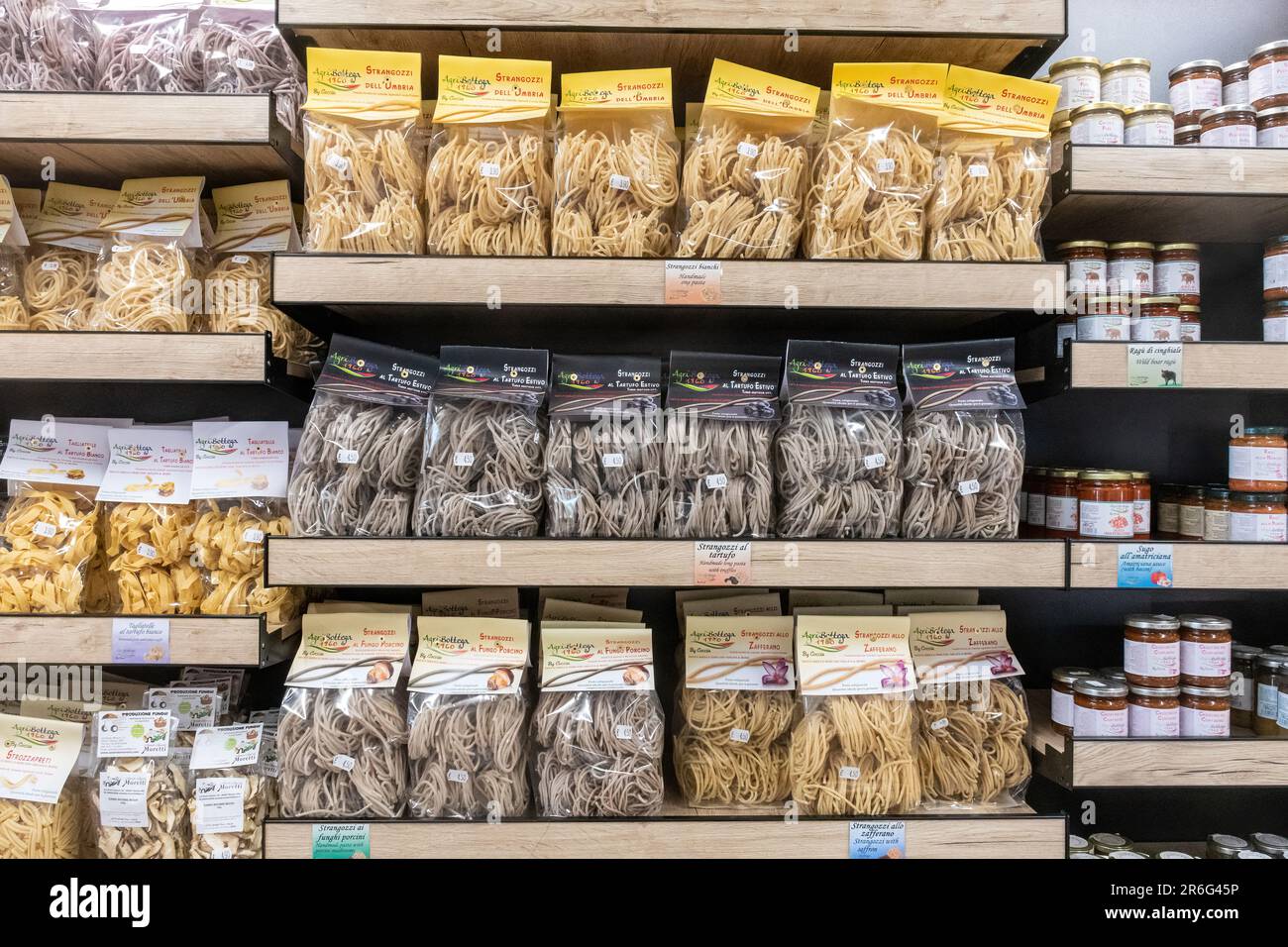Packets of pasta and jars of sauces on shelves in an Italian farm shop, Castelluccio, Umbria, Italy, Europe Stock Photo