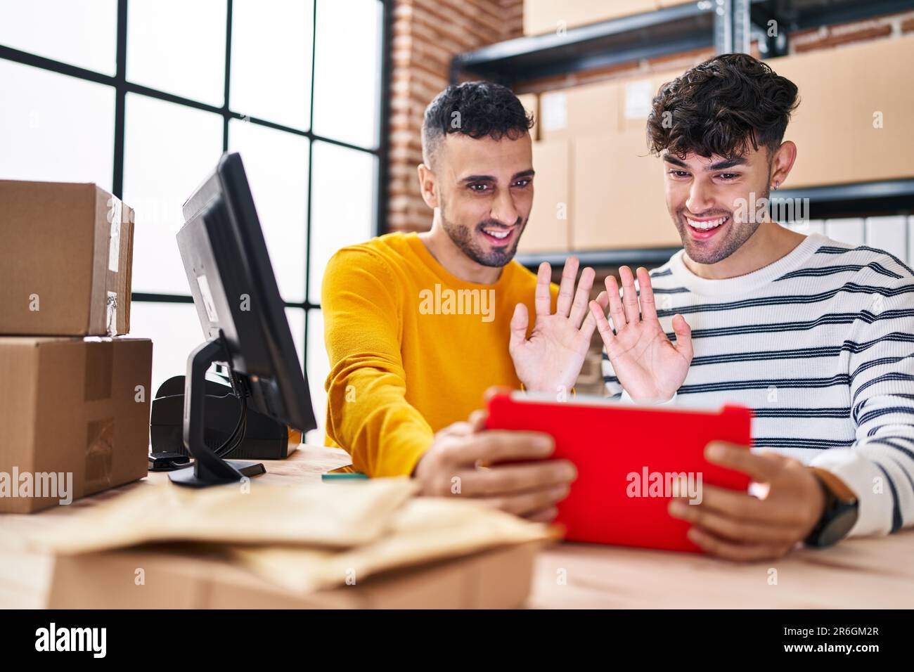 Two man ecommerce business workers having video call working at office Stock Photo