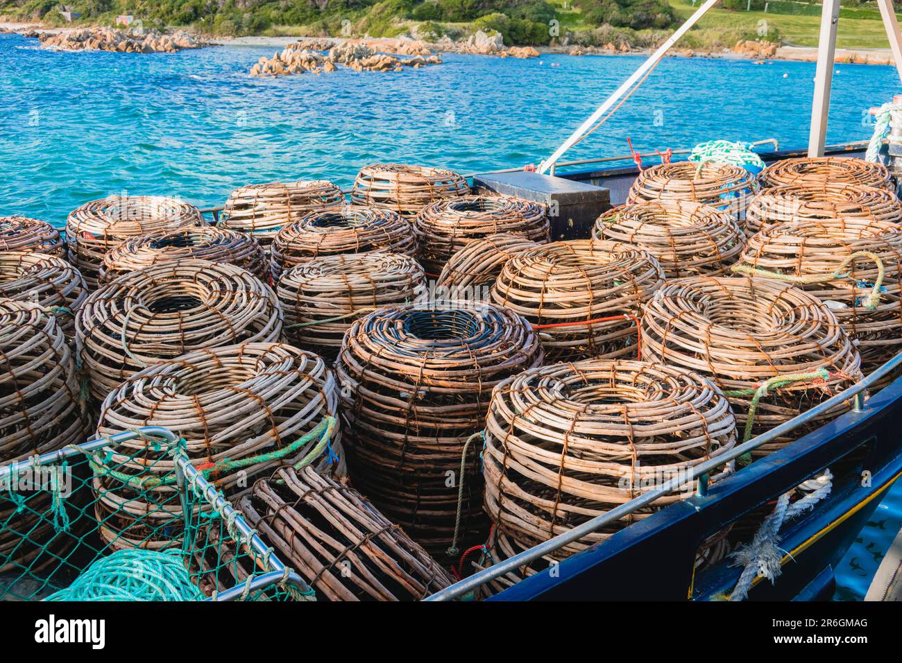 Photograph of many Lobster Pots sitting in a boat on the water on King