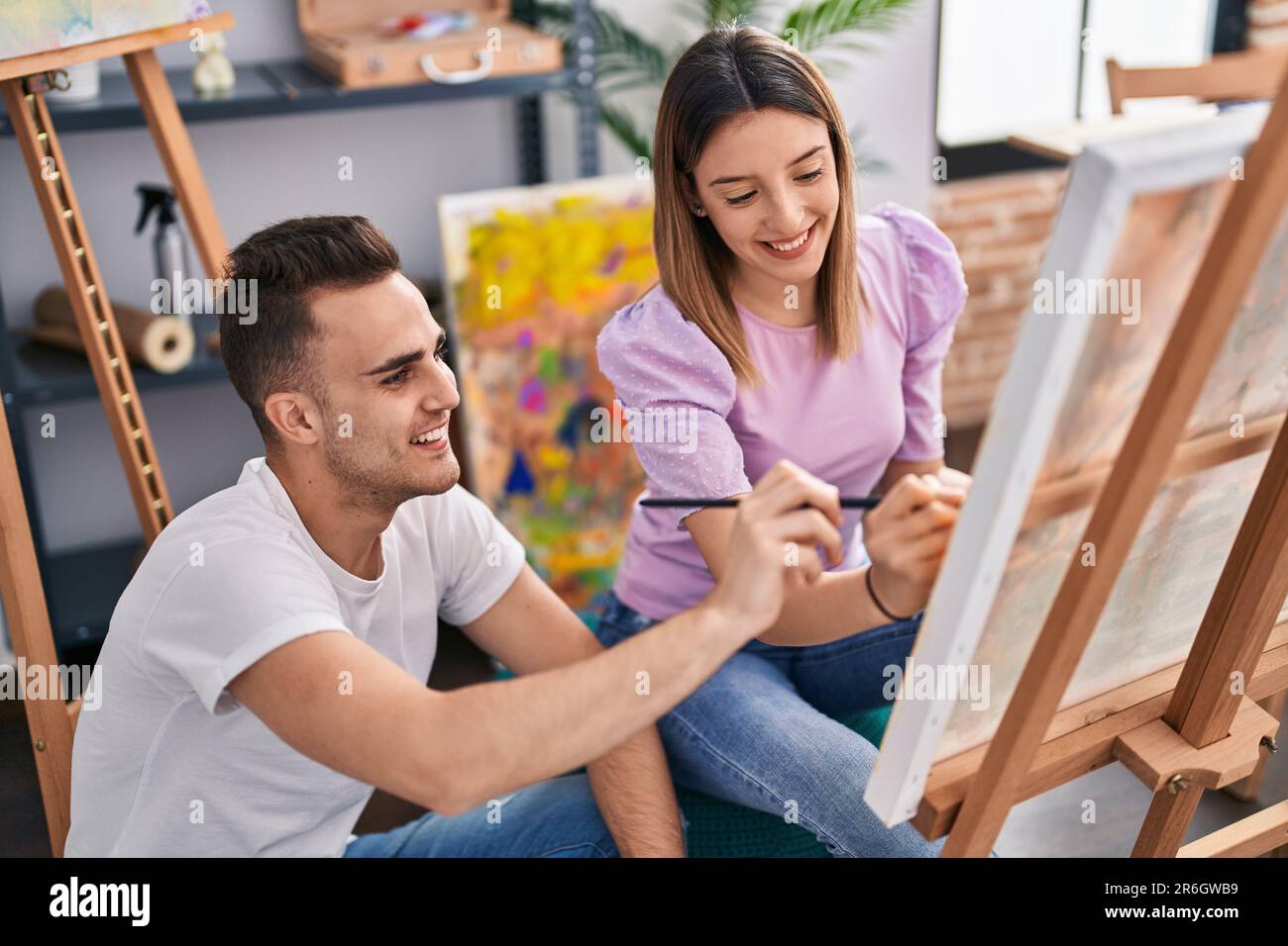 Man and woman artists couple smiling confident drawing at art studio ...