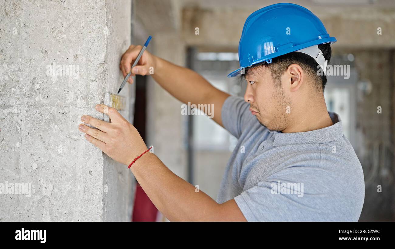 architect writing mark on wall at construction site Stock Photo Alamy