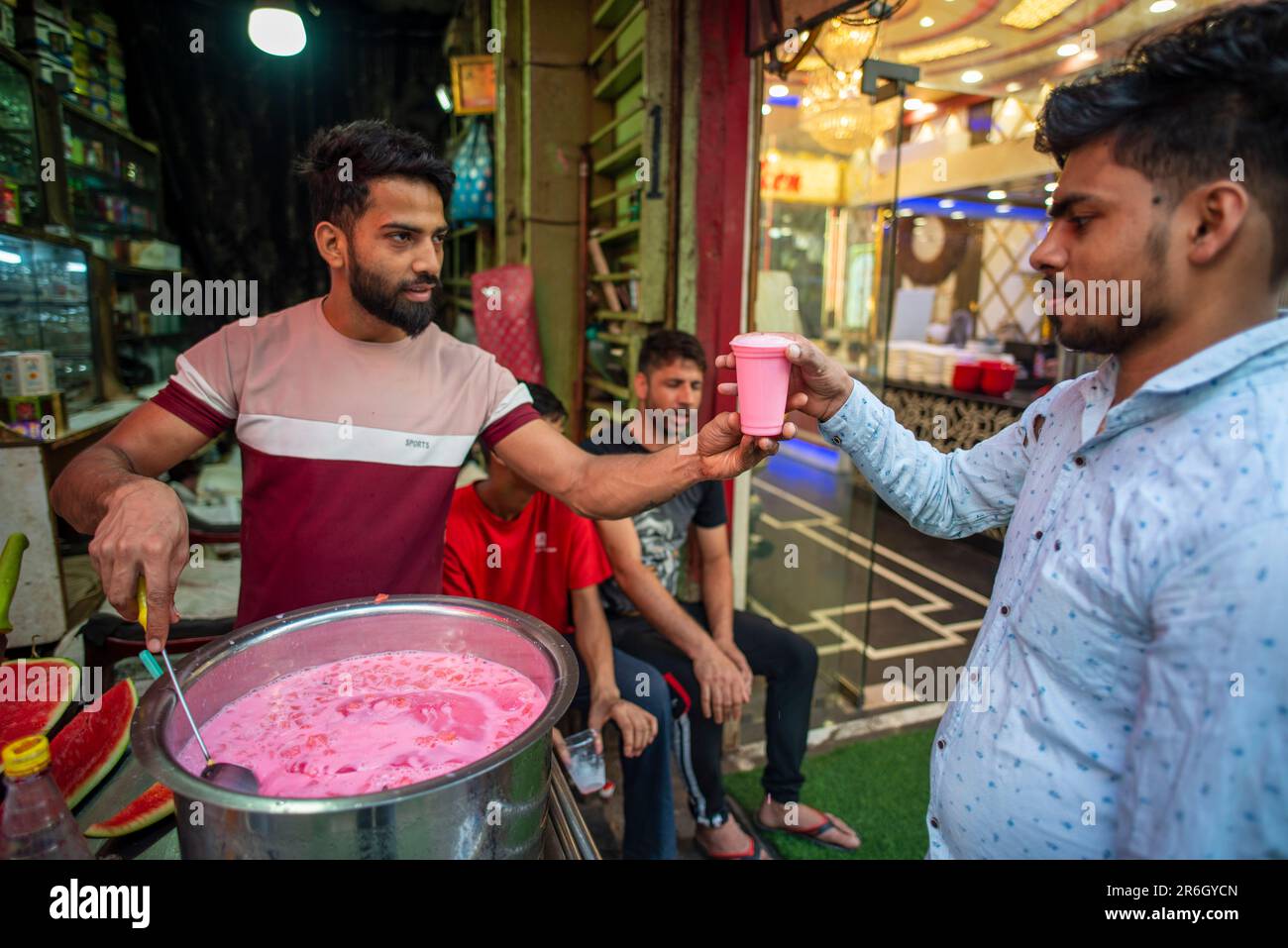 New Delhi, India. 08th June, 2023. Man seen serving Mohabbat Ka Sharbat (Sweet drink made with ice, cold milk, Rooh Afza and watermelon) at Matia Mahal Market, near Jama Masjid. In scorching summer people are used to drink various summer drinks, to beat the heat in capital of India. (Photo by Pradeep Gaur/SOPA Images/Sipa USA) Credit: Sipa USA/Alamy Live News Stock Photo