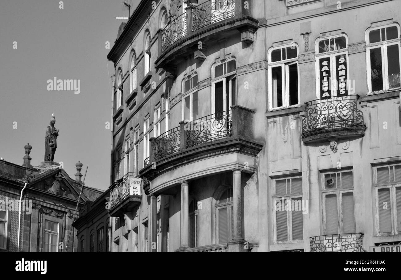 Several facades in Porto City, august 2015 17th. Focus on a rounded facade with some balconies. It's in front of a church, with a statue of the Virgin Stock Photo