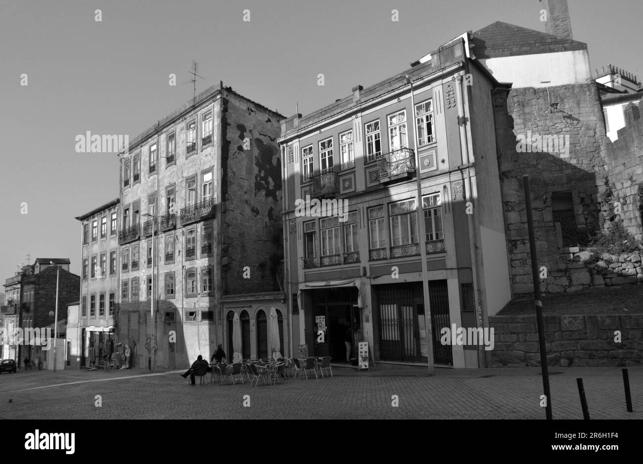 Several facades in Porto City, august 2015 17th. Focus on a small square with a bar, people are drinking coffee. Stock Photo
