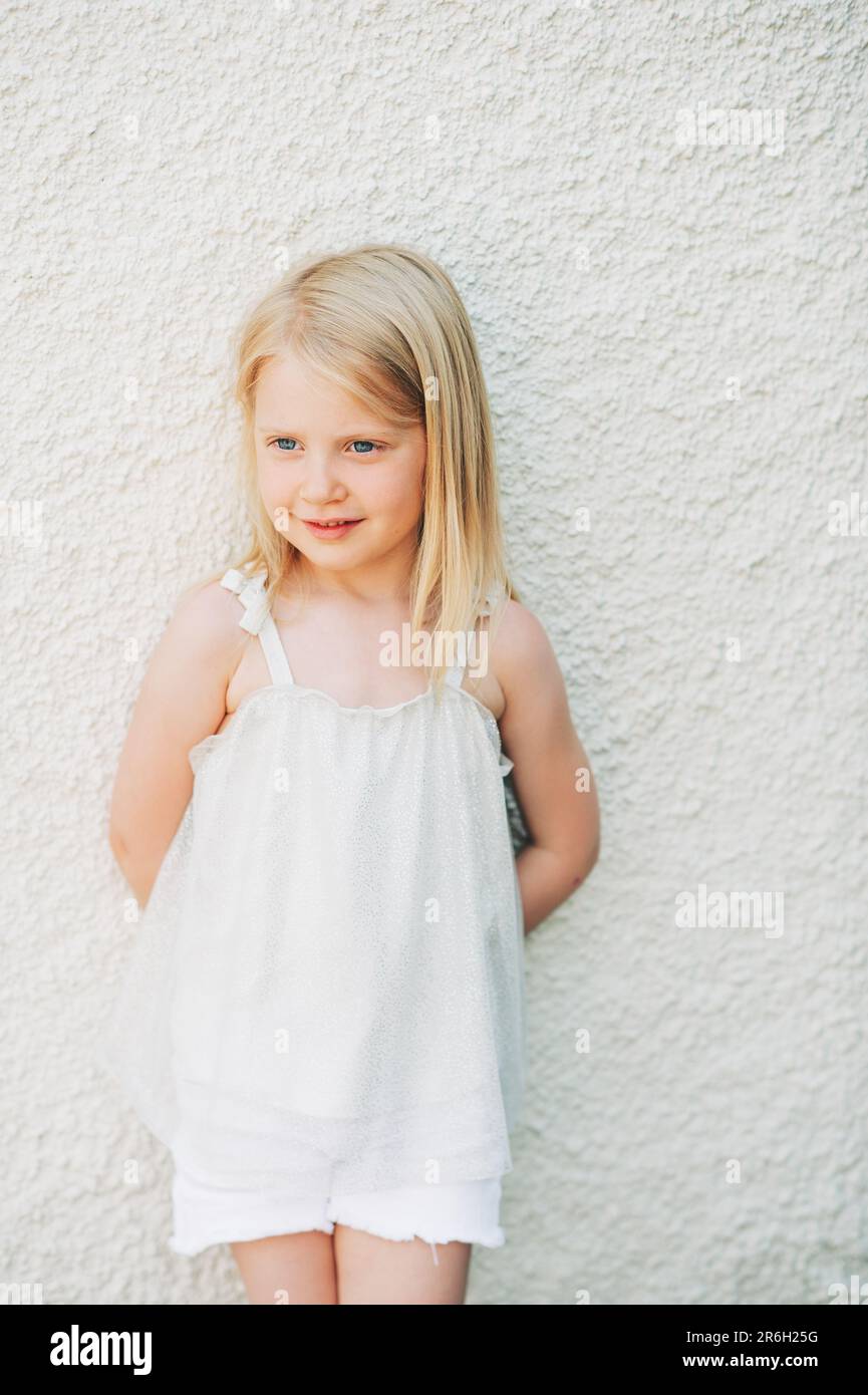Outdoor summer portrait of adorable 5 year old little girl wearing