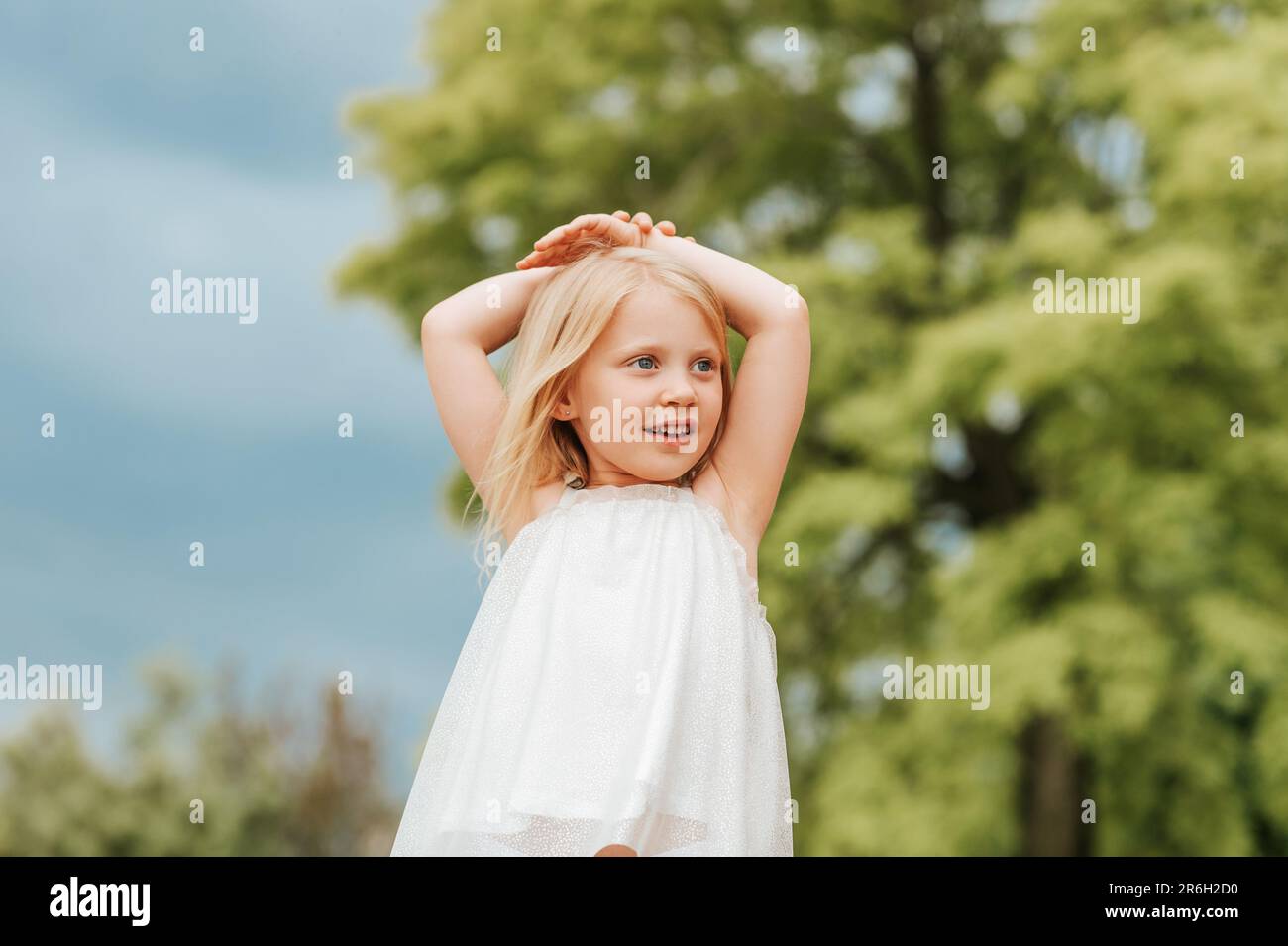 Outdoor portrait of cute little girl with blond hair Stock Photo - Alamy