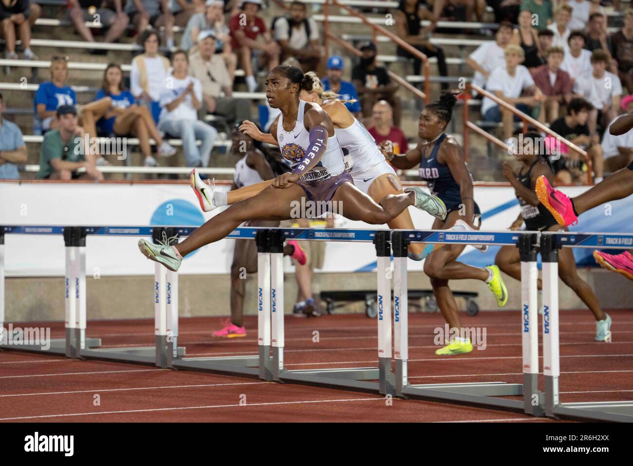 ALIA ARMSTRONG of LSU heads over the 100 meter hurdles in first place