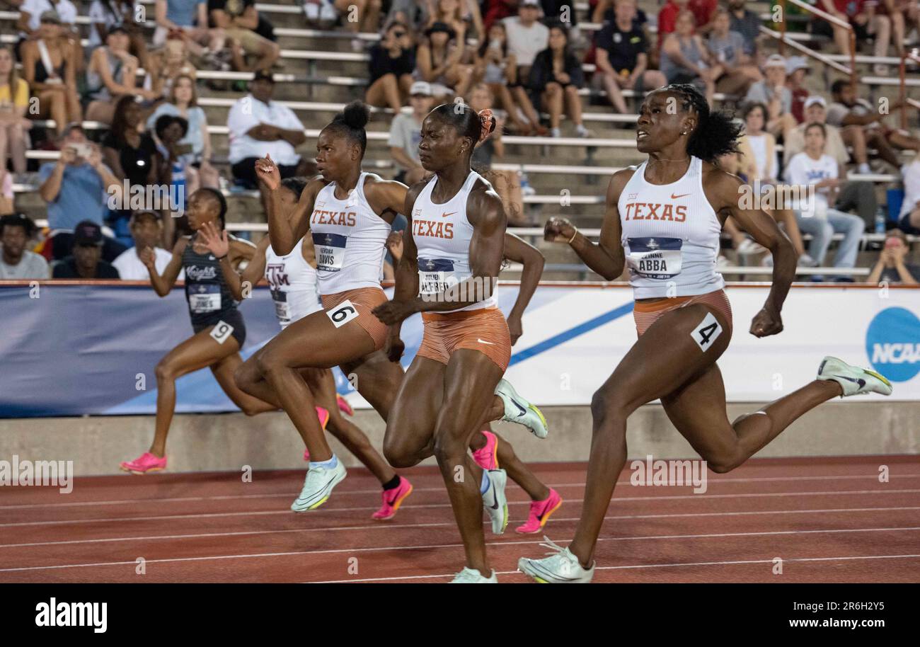Texas sprinters race to the finish line in the first heat of the women
