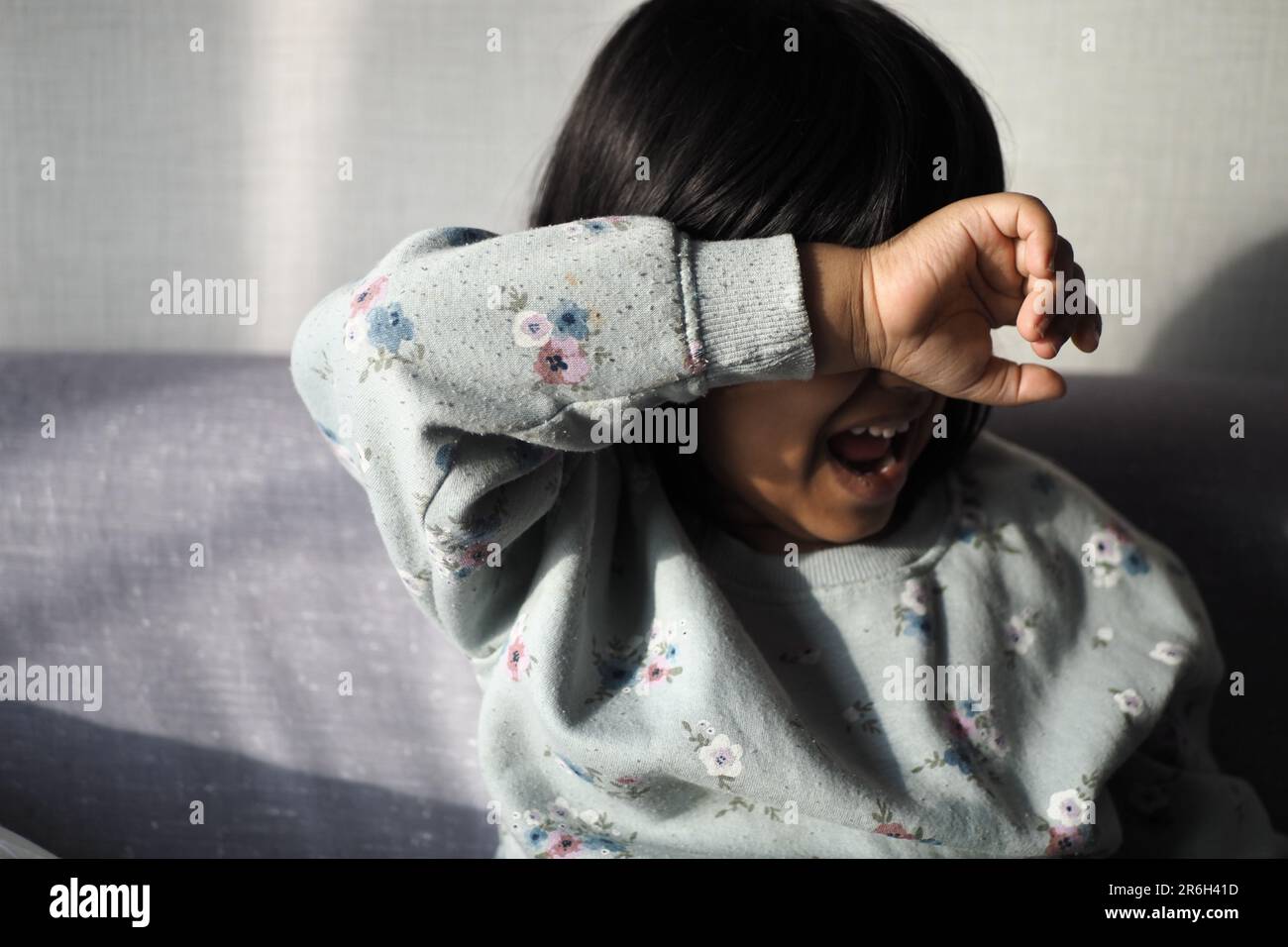 a upset child girl cover her face with hand Stock Photo - Alamy