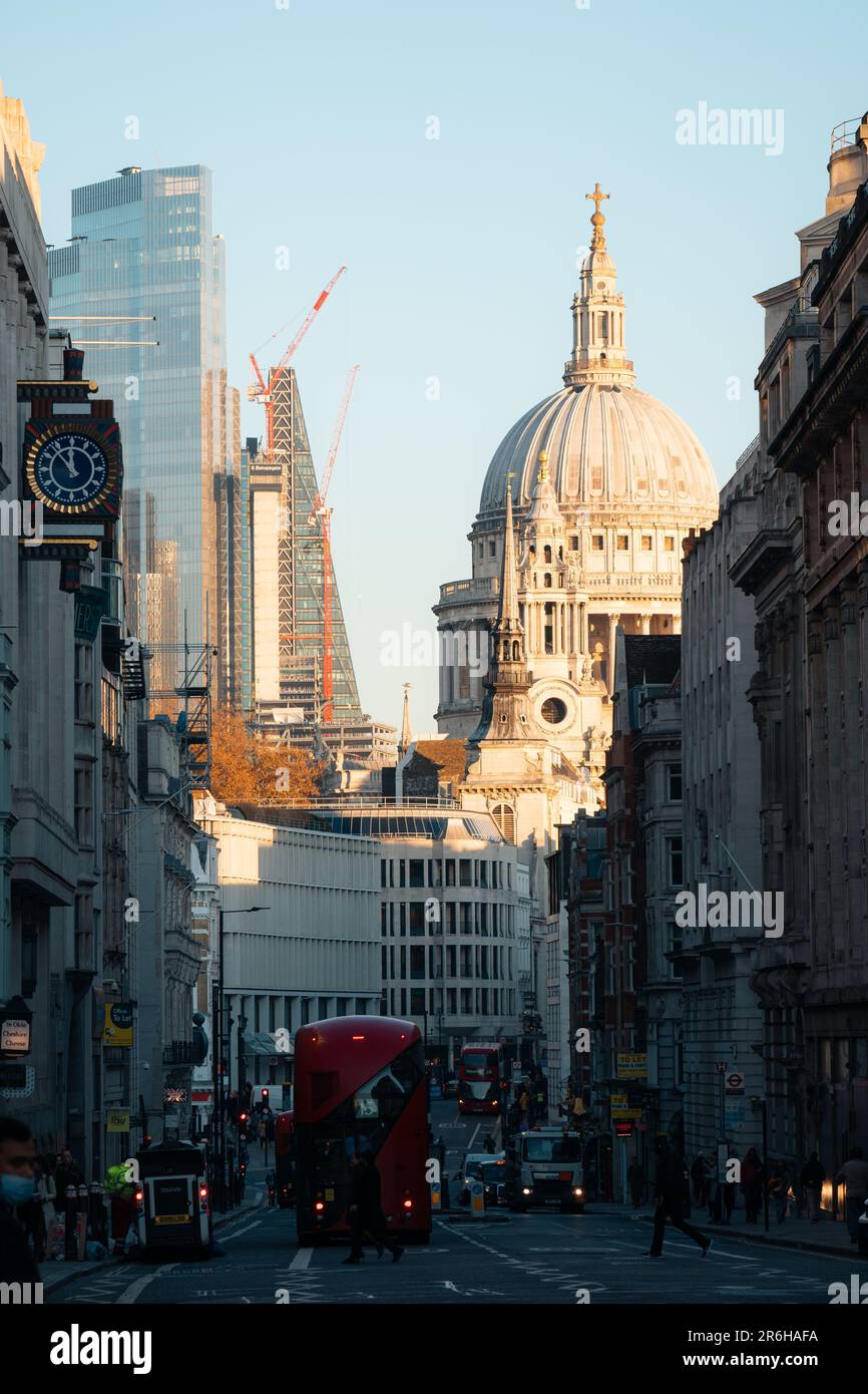 A majestic, domed building stands tall amongst the city skyline, casting an impressive figure against the hustle and bustle of the busy street below Stock Photo
