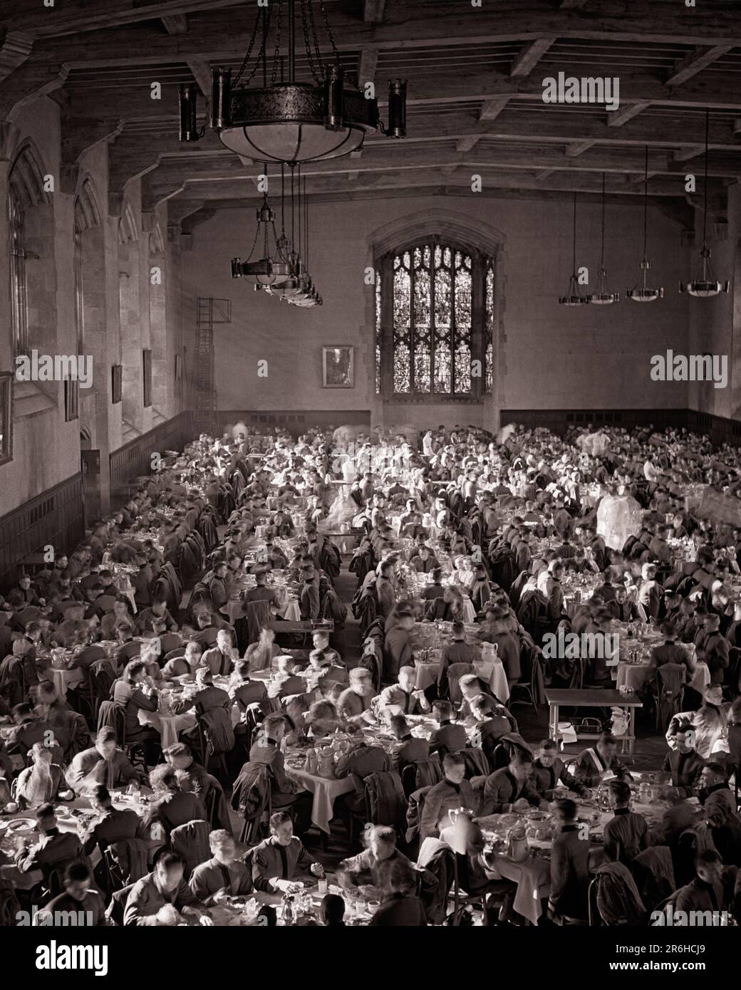 1950s YOUNG MEN ARMY OFFICER CADETS SEATED EATING A LARGE MESS HALL UNITED STATES MILITARY ACADEMY WEST POINT NEW YORK STATE USA - m4775 LAN001 HARS SEATED COPY SPACE FRIENDSHIP HALF-LENGTH PHYSICAL FITNESS PERSONS MALES OFFICER B&W GOALS HIGH ANGLE ADVENTURE STRATEGY ACADEMY EXCITEMENT LEADERSHIP NUTRITION PRIDE NEW YORK STATE OCCUPATIONS UNIFORMS CADETS MOTION BLUR CONSUME CONSUMING NOURISHMENT TEENAGED YOUNGSTERS COOPERATION GROWTH TOGETHERNESS YOUNG ADULT MAN BLACK AND WHITE CAUCASIAN ETHNICITY OLD FASHIONED Stock Photo