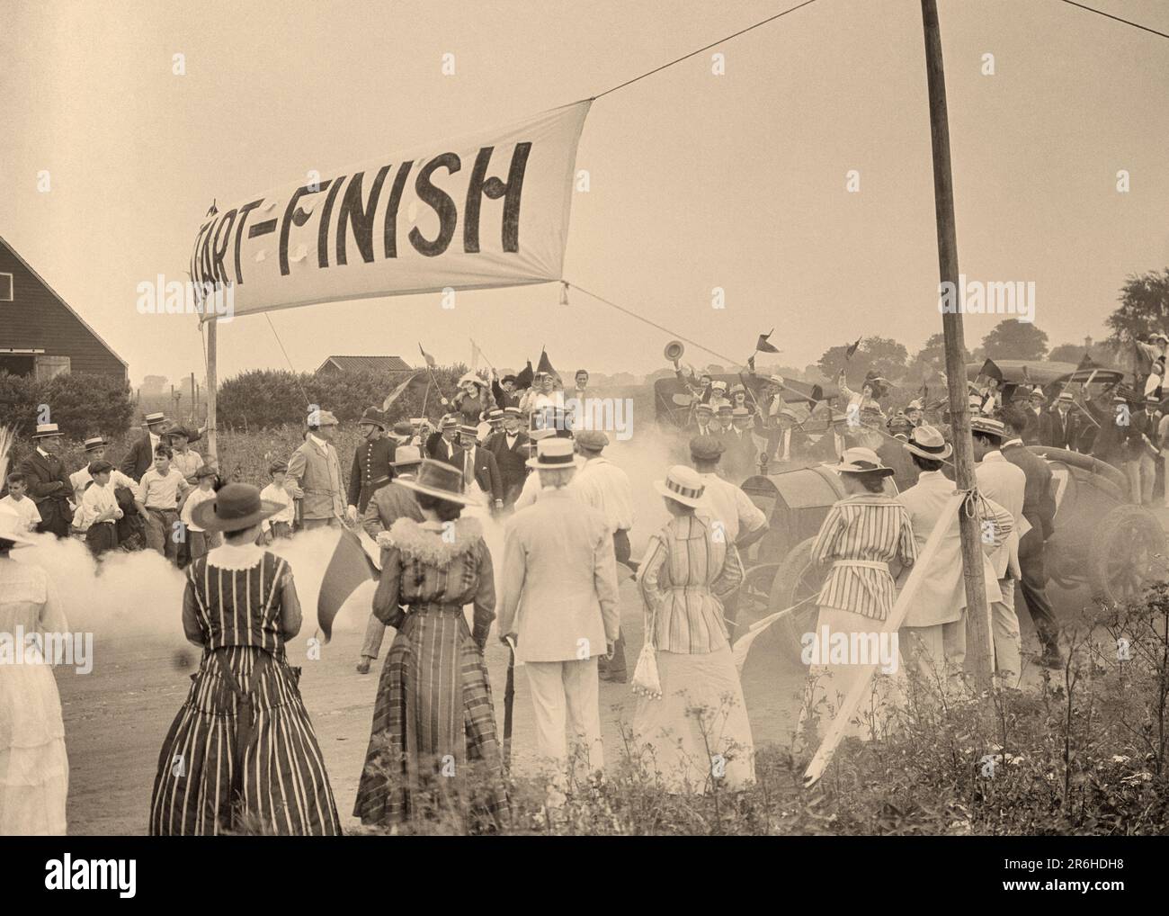 1910s SCENE AT START FINISH LINE OF AUTO RACE FROM THE LOST SILENT FILM THE SCARLET RUNNER FILMED BY VITAGRAPH IN BROOKLYN NY - q45917 CPC001 HARS COMMUNICATION PRODUCTION LOST COSTUMES JOY ACTOR HISTORY CELEBRATION FEMALES UNITED STATES COPY SPACE LADIES PERSONS INSPIRATION UNITED STATES OF AMERICA MALES ENTERTAINMENT TRANSPORTATION SPECTATORS B&W MOVIES BROOKLYN NORTH AMERICA NORTH AMERICAN HAPPINESS HIGH ANGLE ADVENTURE PERFORMER EXCITEMENT FAMOUS ENTERTAINER NYC OCCUPATIONS SILENT NEW YORK ACTORS AUTOMOBILES CITIES COMPANY DRAMA IMAGINATION STYLISH DIRECTED NEW YORK CITY PRODUCING Stock Photo