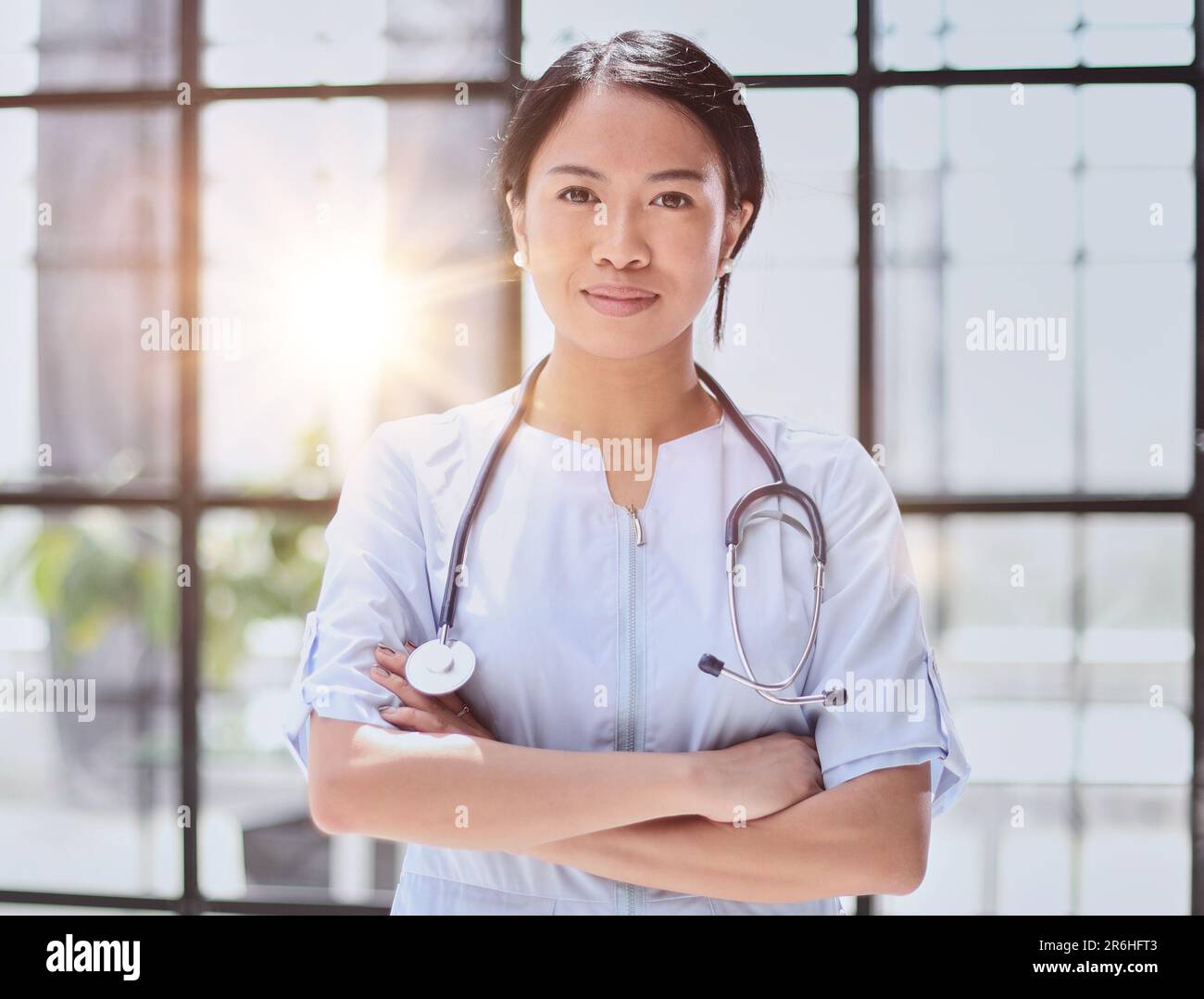 Charming female doctor standing hi-res stock photography and images - Alamy