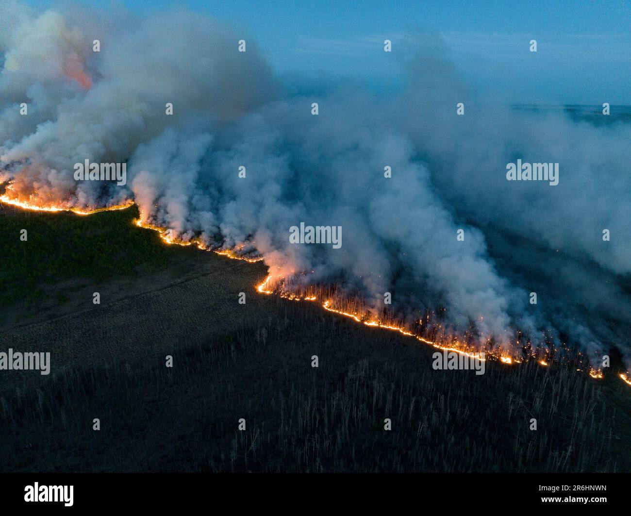 British Columbia, Canada. 10th June, 2023. (230609) -- BRITISH COLUMBIA (CANADA), June 9, 2023 (Xinhua) -- Undated aerial photo provided by BC Wildfire Service on June 9, 2023 shows wildfires burning in Northeast region of British Columbia, Canada. With more than nine million acres of land burnt, over 20,000 residents evacuated and at least 400 fires still active, half of which are believed out of control, a staggering series of figures revealed on Wednesday by Canadian Minister of Emergency Preparedness Bill Blair showed that the country is facing an unprecedented battle against the raging wi Stock Photo