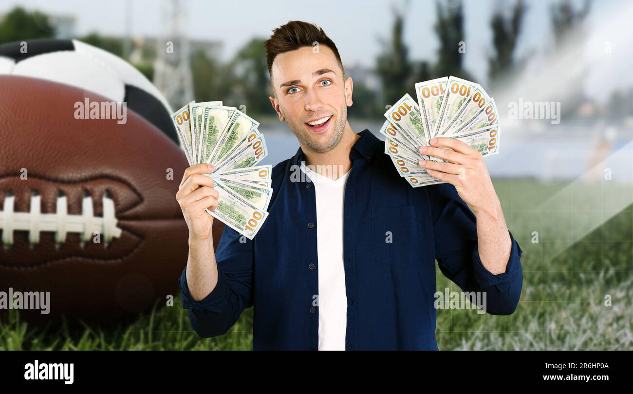 Sports betting. Happy winner holding cash fans. Stadium with different balls on background Stock Photo
