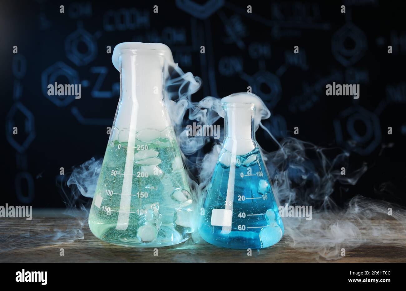Science Steam Color Laboratory glassware with colorful liquids and steam on wooden table ...