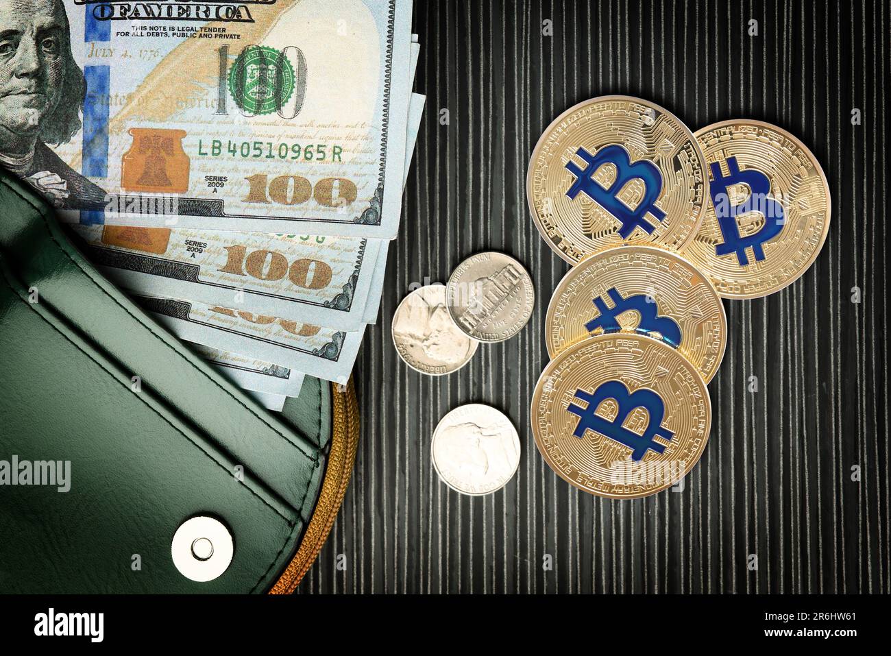 Bitcoins, dollar banknotes, coins and wallet on black wooden background,  flat lay Stock Photo - Alamy
