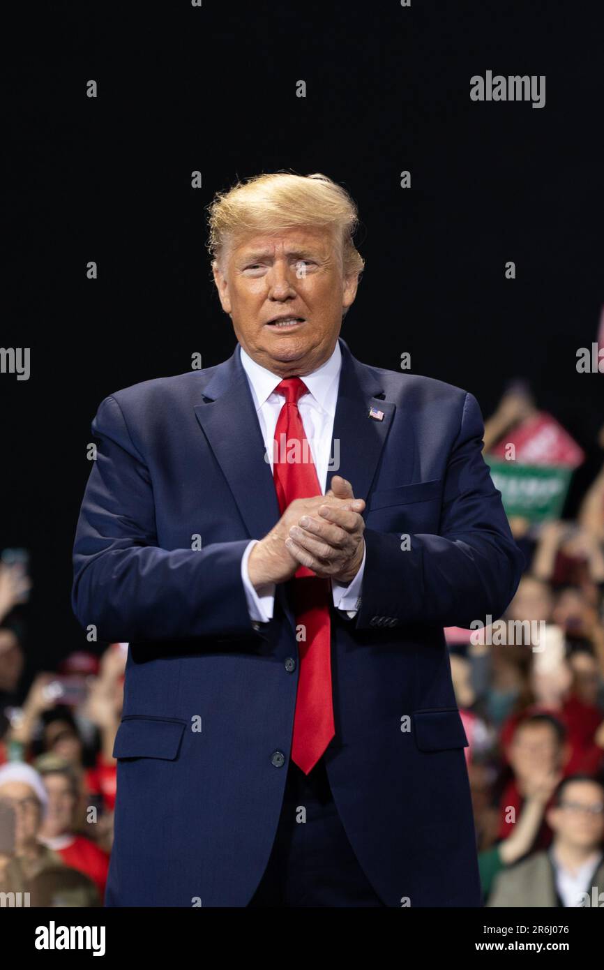 President Donald Trump speaks at a rally in Battle Creek, Michigan concurrent to the House of Representatives voting to impeach him. Stock Photo