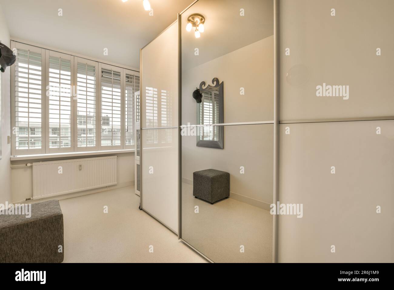 a very clean white room with lots of light coming in through the window ...