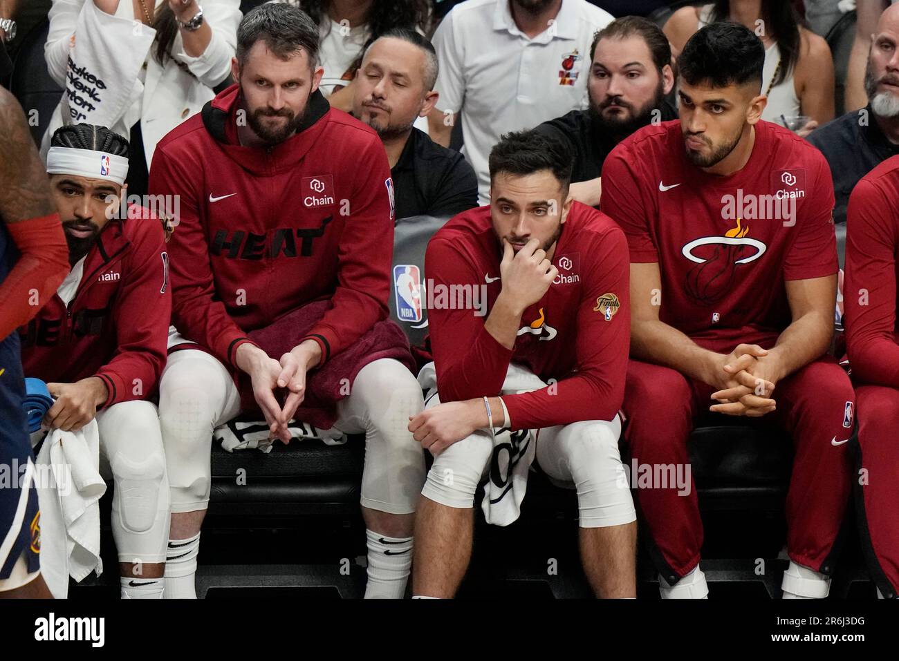 Miami Heat players sit on the bench as the team falls behind the Denver