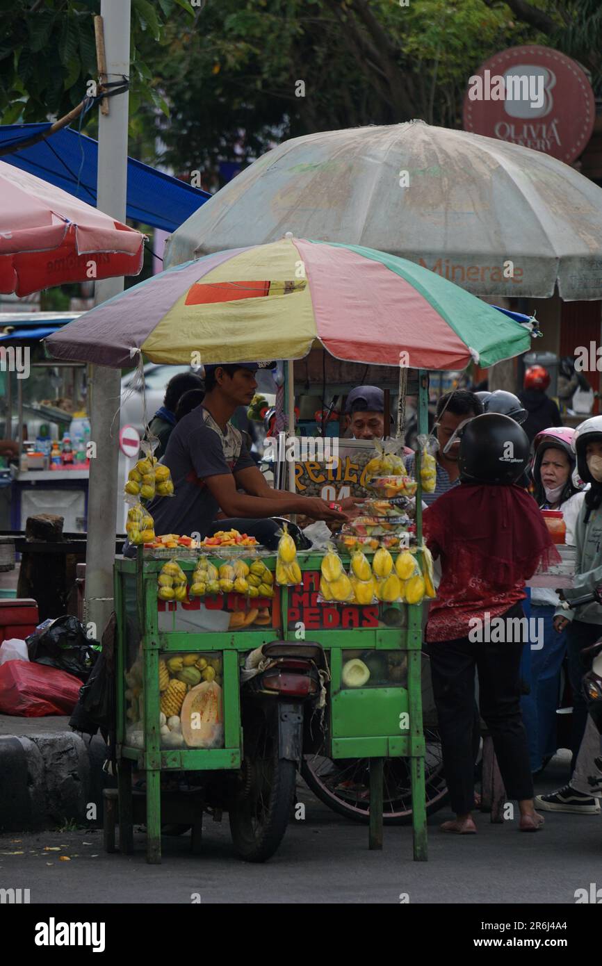 The seller of manisan. Candied golden apple fruit (manisan kedondong
