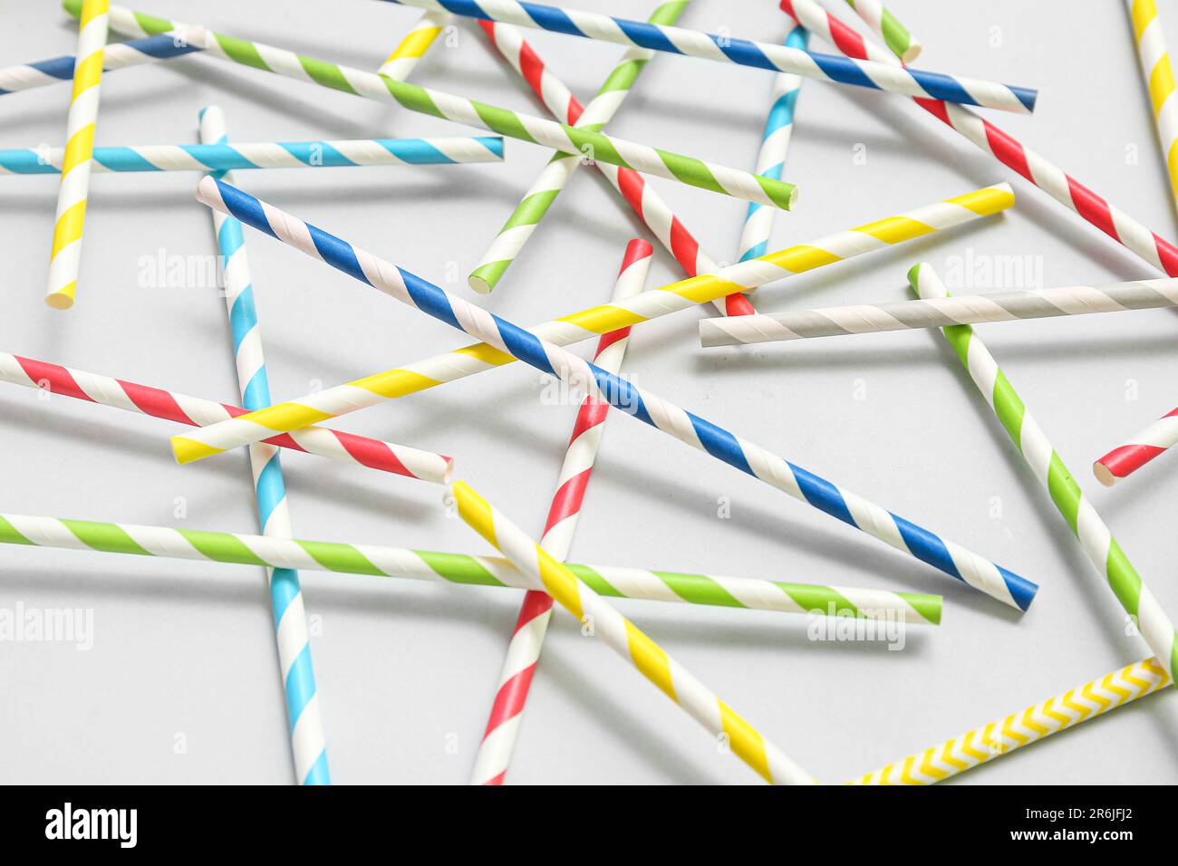 Different paper drinking straws on blue background Stock Photo