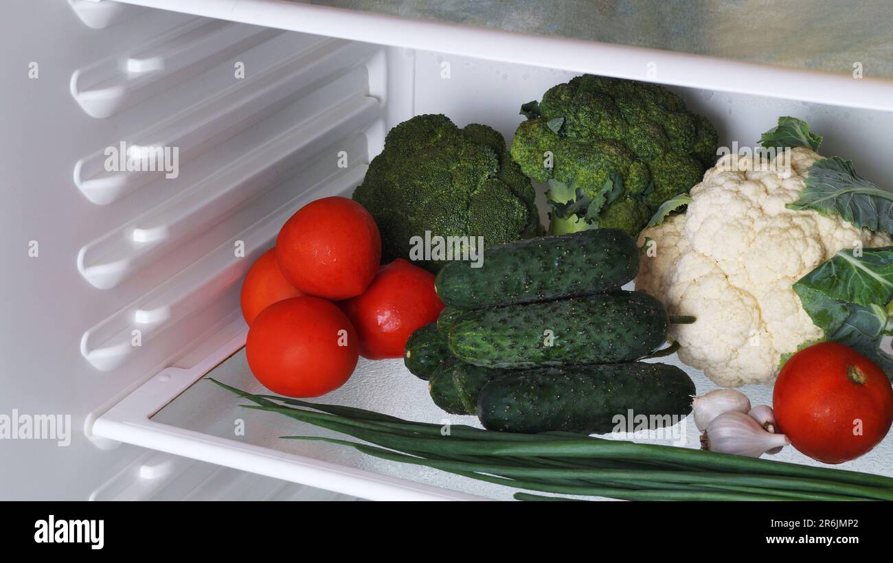 Many different fresh vegetables on refrigerator shelf Stock Photo