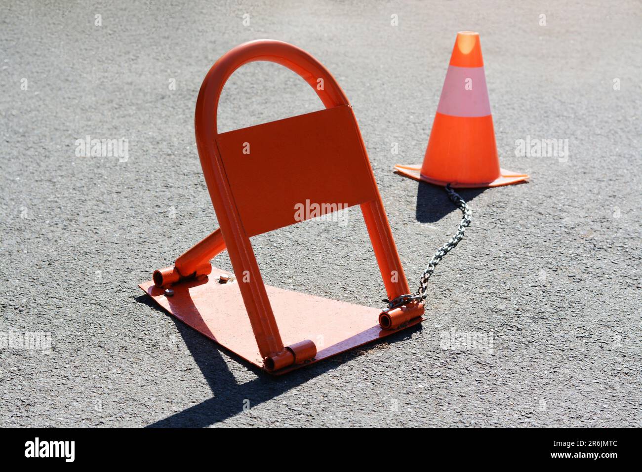 Parking barrier with No Stopping road sign on it and traffic cone