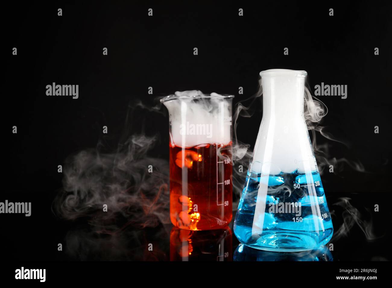 Science Steam Color Laboratory glassware with colorful liquids and steam on black ...