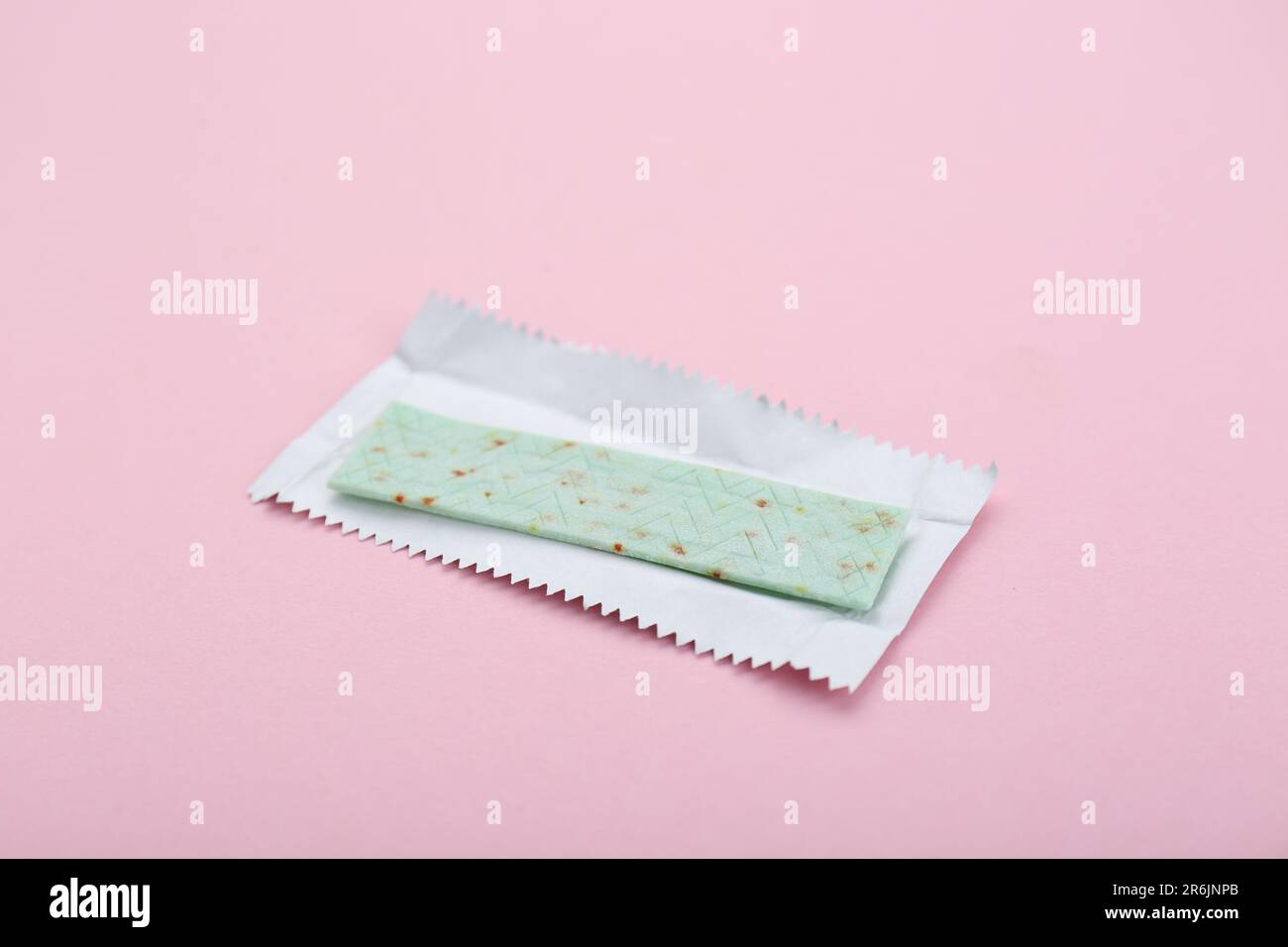 Unwrapped stick of chewing gum on pink background, closeup Stock Photo