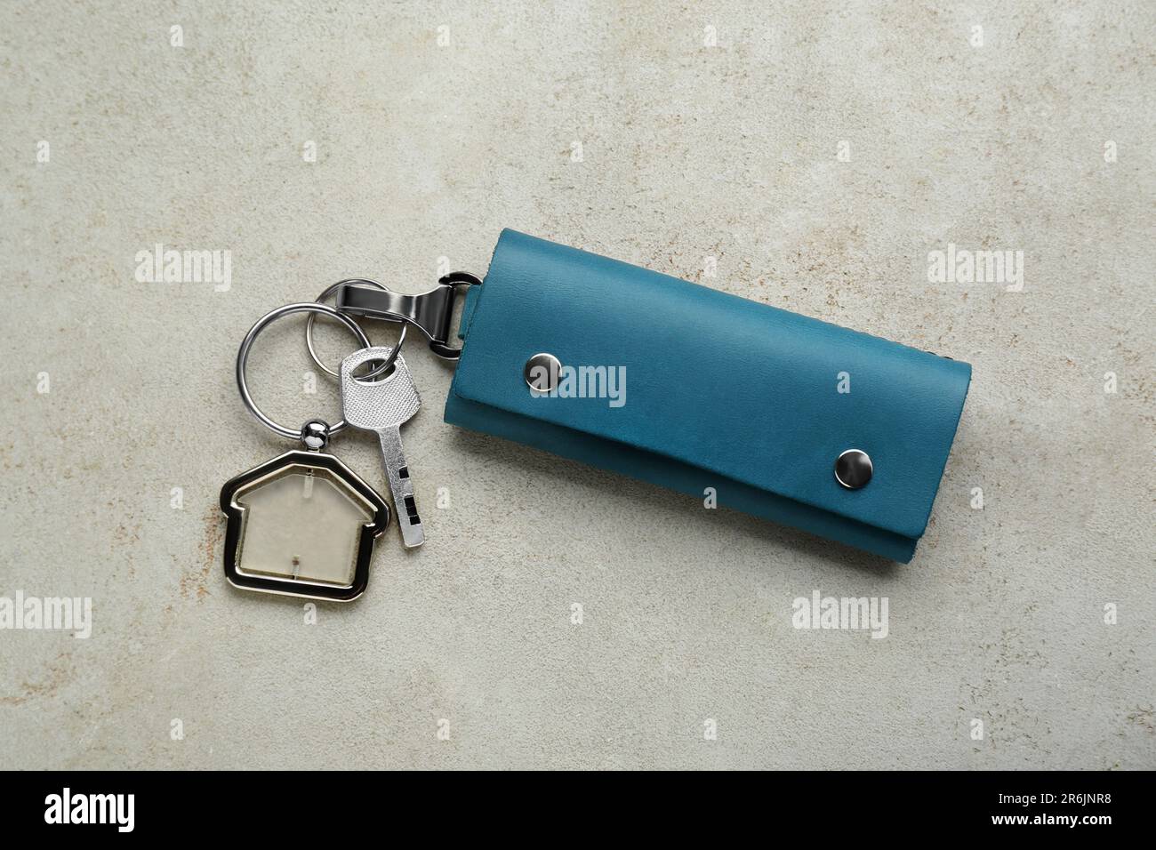 Leather case with key on light grey table, top view Stock Photo