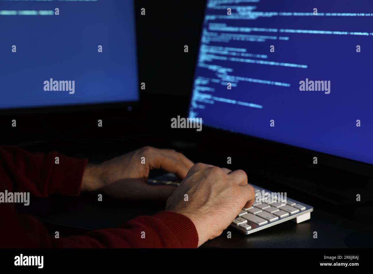 Hacker working with computers in dark room, closeup. Cyber attack Stock ...