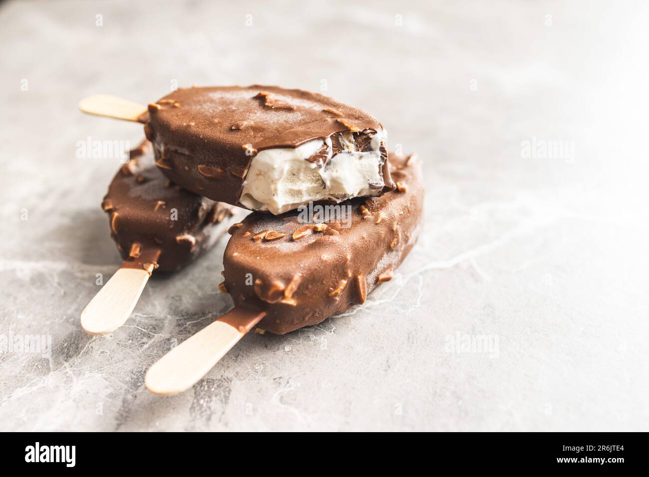 Popsicle, ice cream covered with chocolate on the kitchen table. Stock Photo