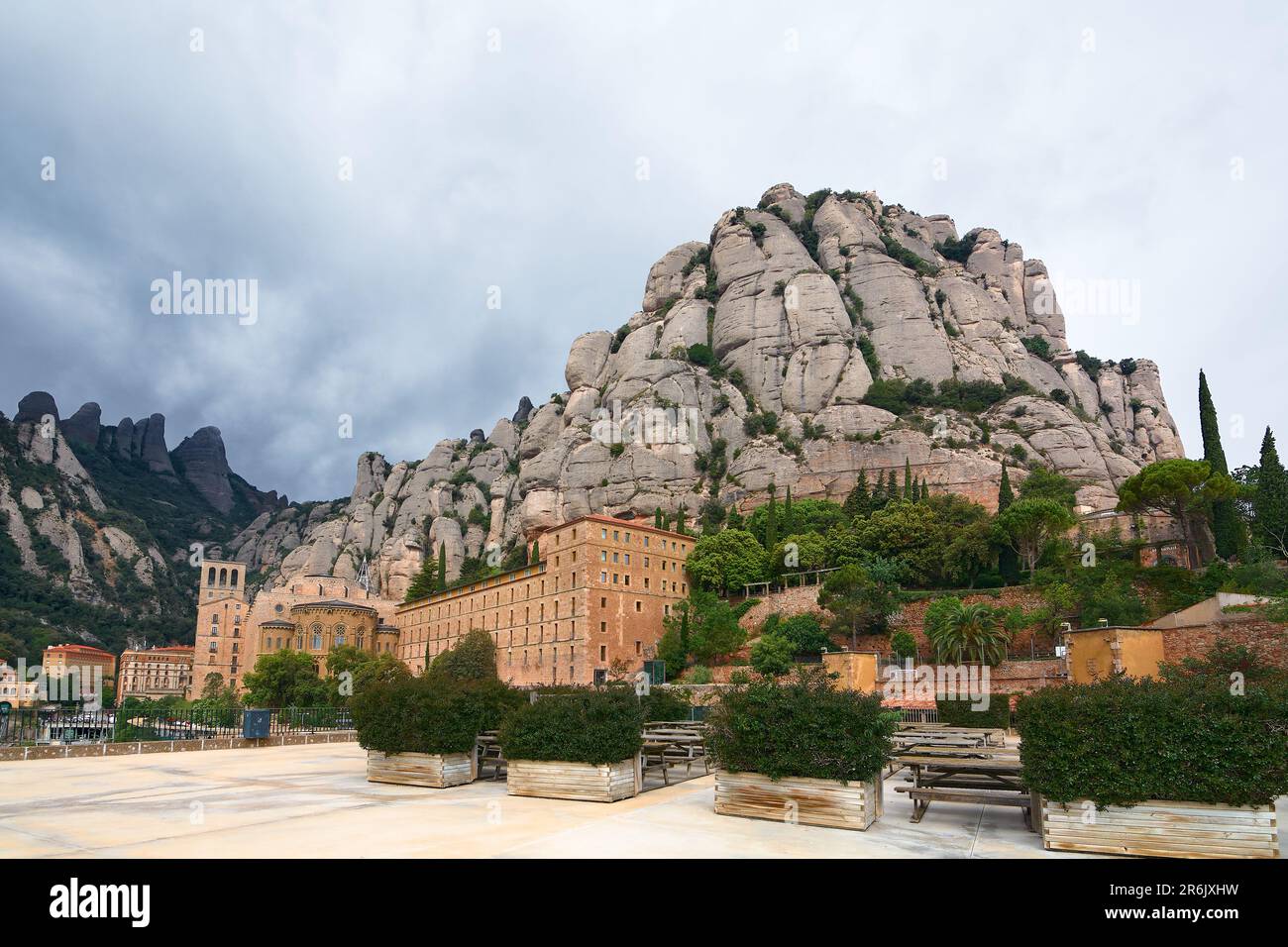 Santa Mar a de Montserrat in Monistrol, on a partly cloudy day in Catalonia, Spain with its characteristic rocks in the background. Stock Photo