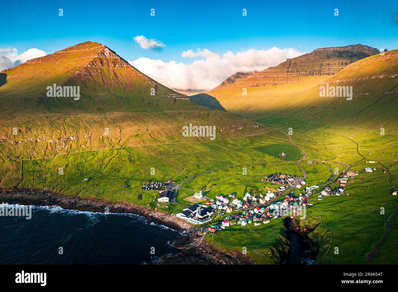 Aerial view of the coastal village of Gjogv and mountains at sunrise, Eysturoy Island, Faroe Islands, Denmark, Europe Stock Photo